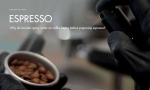 Why do baristas spray water on coffee beans?